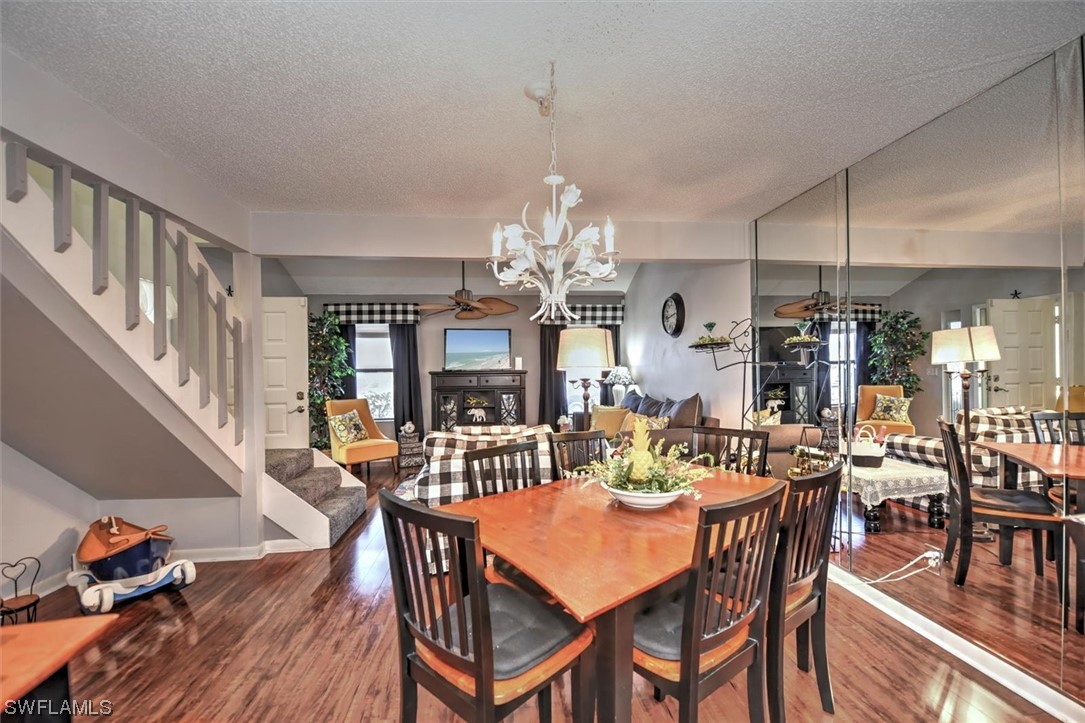 13260 Broadhurst Loop Fort Myers, FL 33919 - Photo 7 of 25 a view of a dining room and livingroom with furniture wooden floor a chandelier