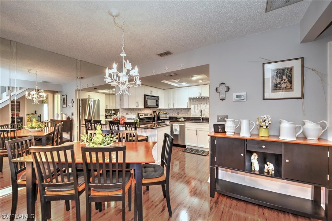 13260 Broadhurst Loop Fort Myers, FL 33919 - Photo 10 of 25 a view of a dining room with furniture and chandelier