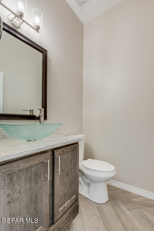 12432 Fill Ball El Paso, TX 79928 - Photo 18 of 37 a bathroom with a granite countertop toilet and a sink