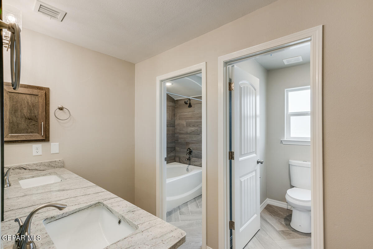 12432 Fill Ball El Paso, TX 79928 - Photo 23 of 37 a bathroom with a sink toilet and shower