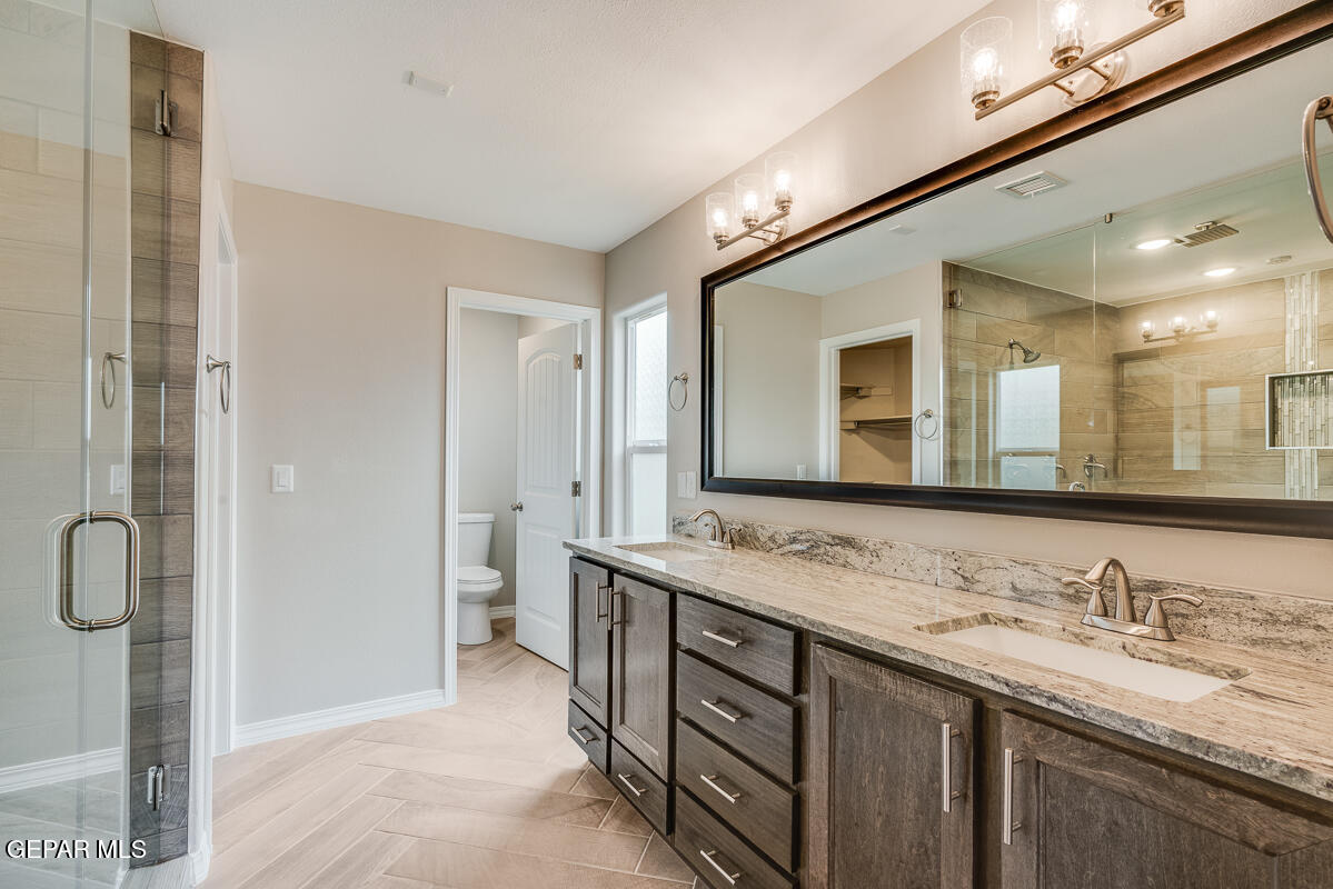 12432 Fill Ball El Paso, TX 79928 - Photo 33 of 37 a bathroom with a granite countertop sink mirror and double