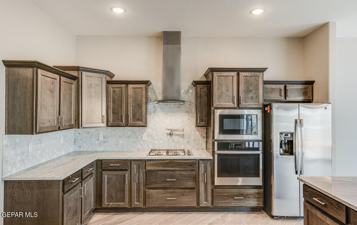 12432 Fill Ball El Paso, TX 79928 - Photo 10 of 37 a kitchen with cabinets and stainless steel appliances