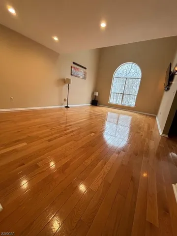 a view of room with window and wooden floor