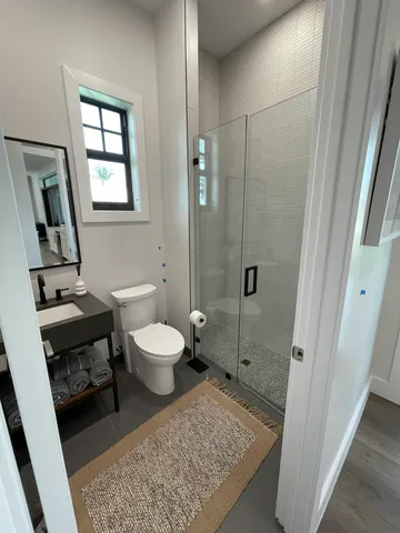 a bathroom with a toilet a sink and a mirror