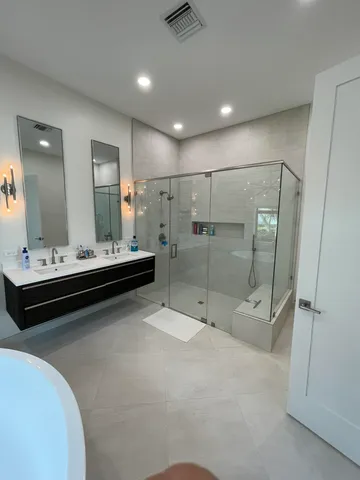 a bathroom with a double vanity sink and mirror