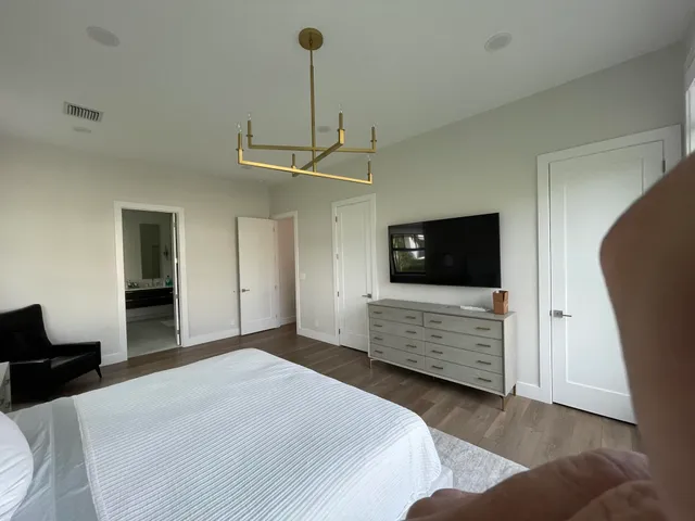 a bedroom with a bed and a television