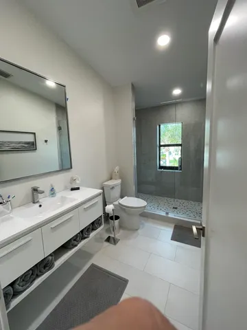 a bathroom with a double vanity sink and mirror