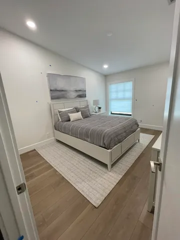 a bedroom with a bed and a night stand