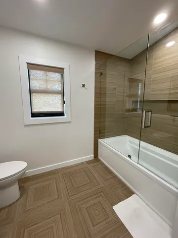 a bathroom with a bathtub and a shower