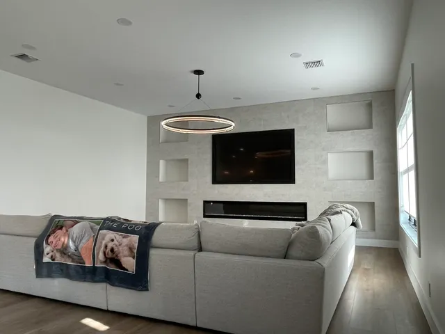 a living room with furniture and a fireplace