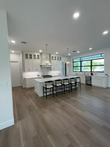 a room with lots of furniture and view kitchen