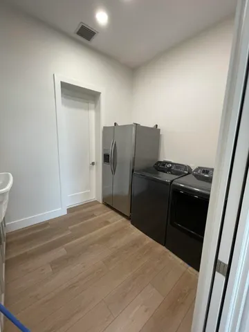 a kitchen with a refrigerator stove and sink