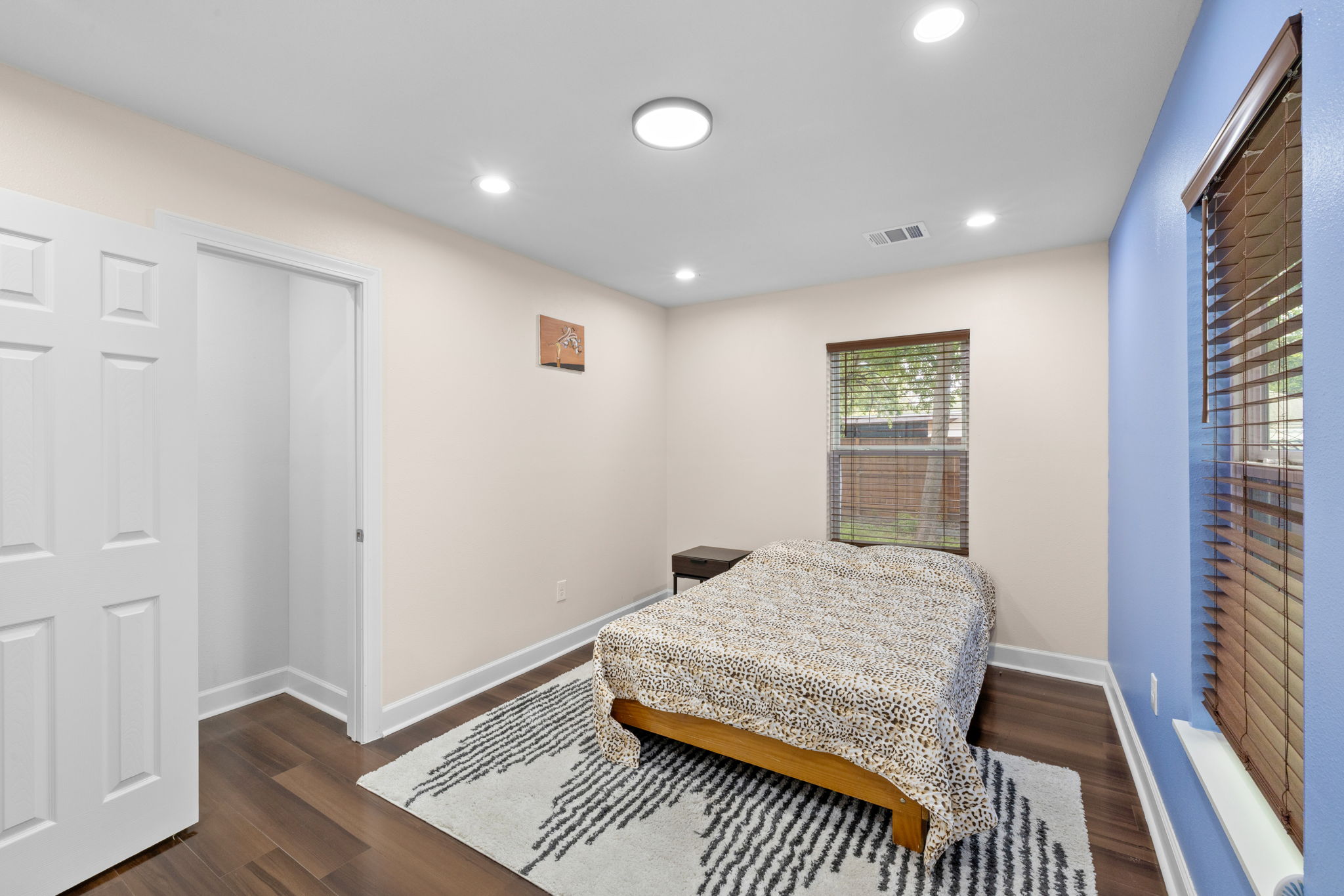907 East 53rd Street Austin, TX 78751 - Photo 21 of 36 Well-lit sleeping quarters with rich hardwood flooring and bright recessed lighting.