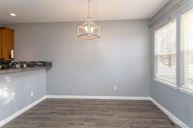 a view of a room with wooden floor and a window