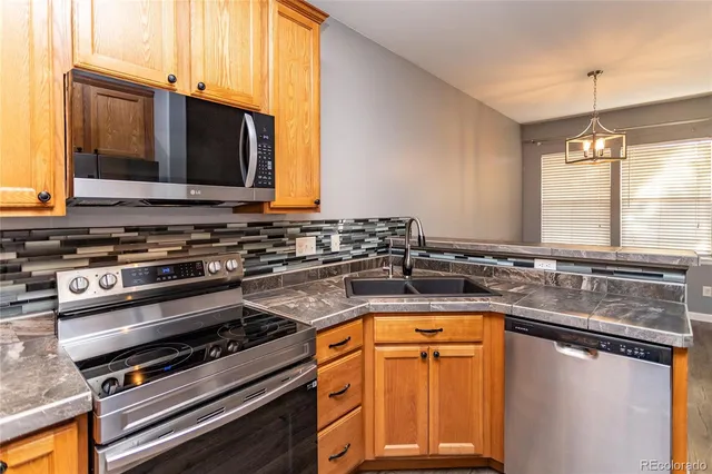 a kitchen with a sink stove and microwave