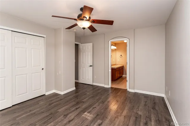 a view of a room with wooden floor closet and chandelier