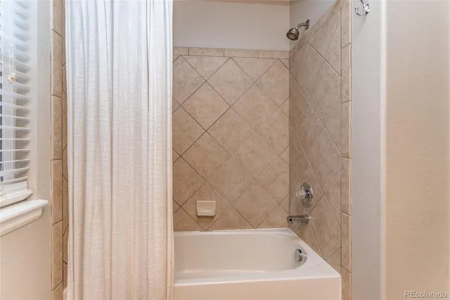 a bath tub sitting next to a white sink