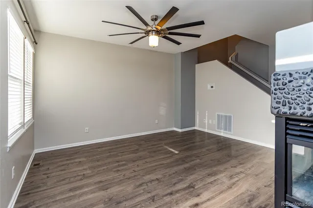 wooden floor in an empty room with a window