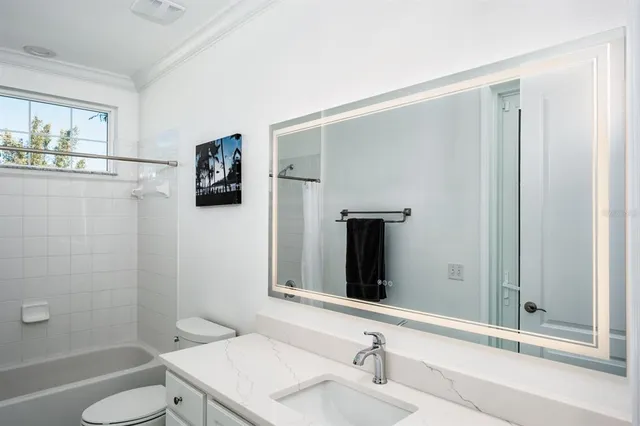 a bedroom with a large bed and a couch