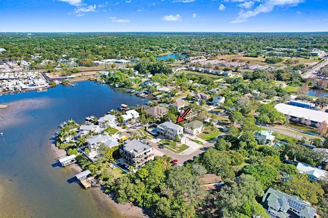 an aerial view of a house with a swimming pool outdoor seating and yard