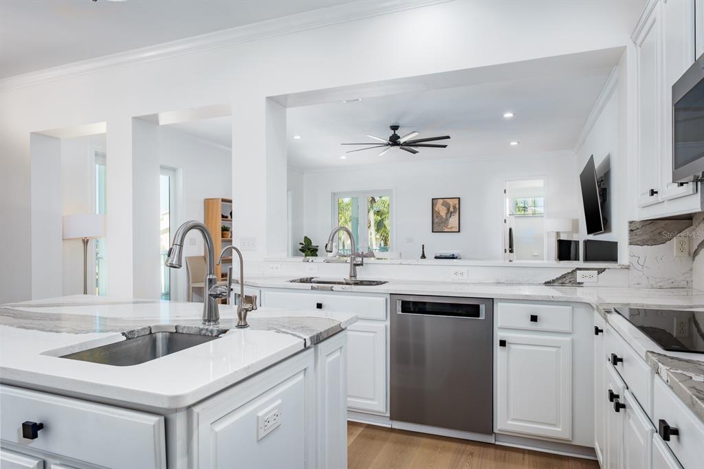 1700 Oyster Point Way Palm Harbor, FL 34683 - Photo 25 of 88 a kitchen with a sink stove and cabinets