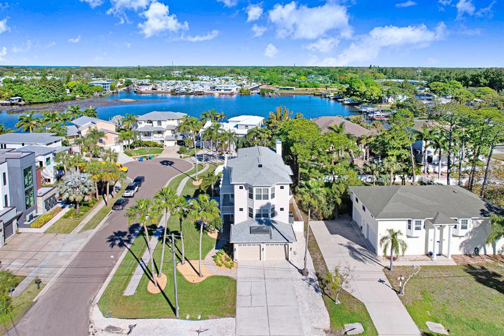 1700 Oyster Point Way Palm Harbor, FL 34683 - Photo 3 of 88 an aerial view of a house with a swimming pool outdoor seating and yard