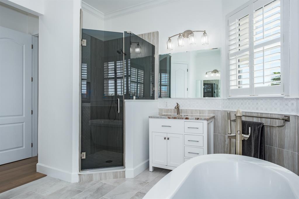 1700 Oyster Point Way Palm Harbor, FL 34683 - Photo 39 of 88 a spacious bathroom with a sink and a mirror