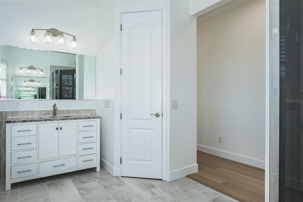 1700 Oyster Point Way Palm Harbor, FL 34683 - Photo 40 of 88 a bathroom with a granite countertop sink and a mirror