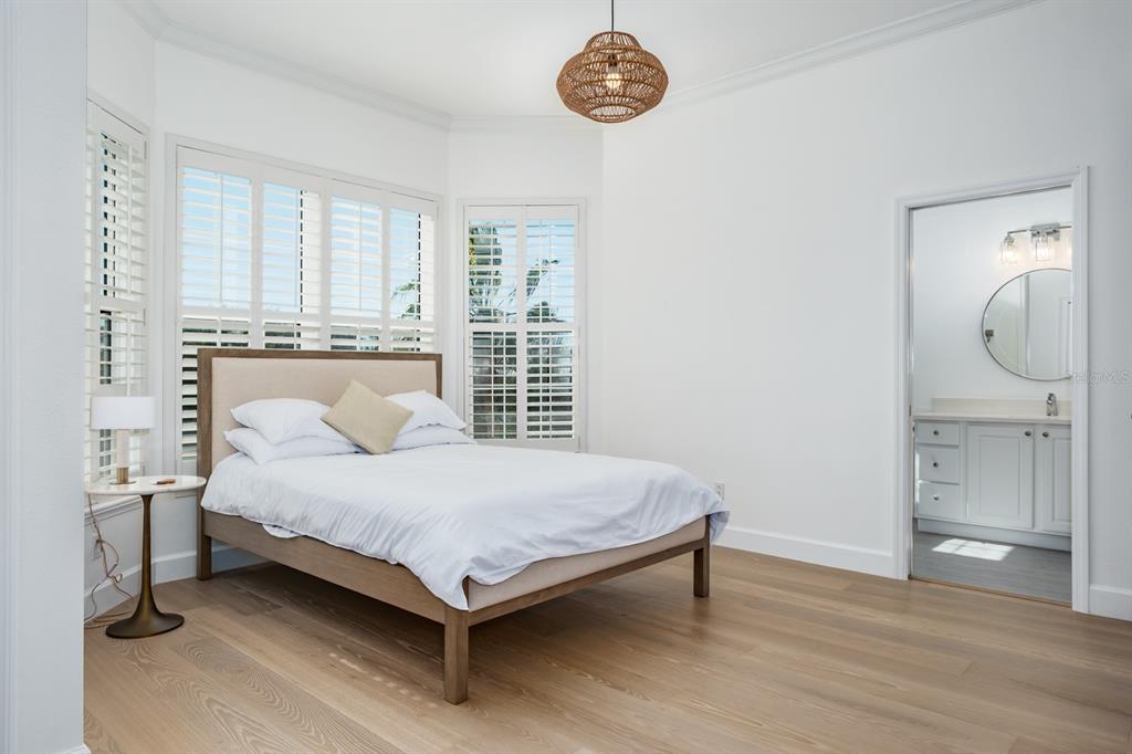 1700 Oyster Point Way Palm Harbor, FL 34683 - Photo 43 of 88 a bedroom with a bed and a table