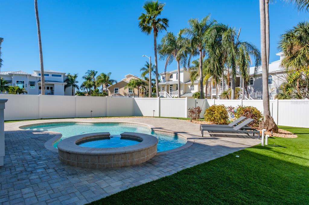 1700 Oyster Point Way Palm Harbor, FL 34683 - Photo 62 of 88 a view of a backyard with plants and swimming pool