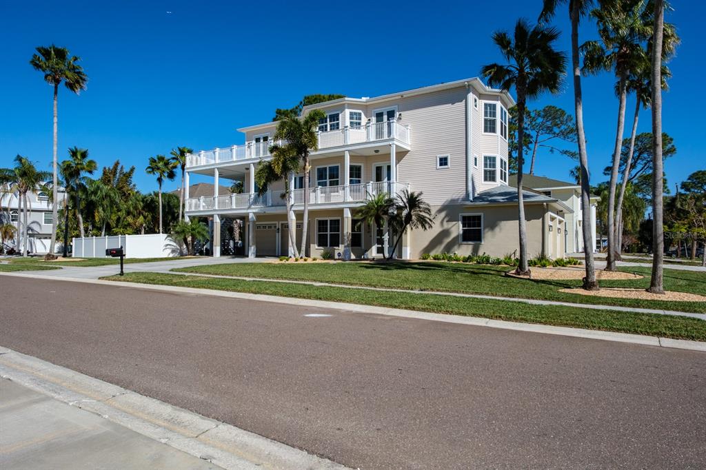 1700 Oyster Point Way Palm Harbor, FL 34683 - Photo 8 of 88 a view of a house with a big yard and potted plants