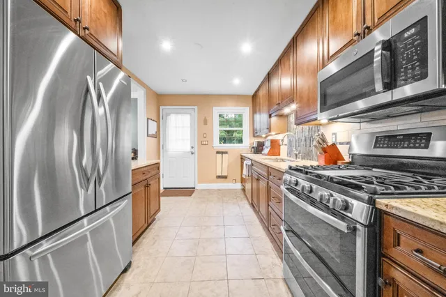 a dining room with wooden floor a chandelier a wooden table and chairs