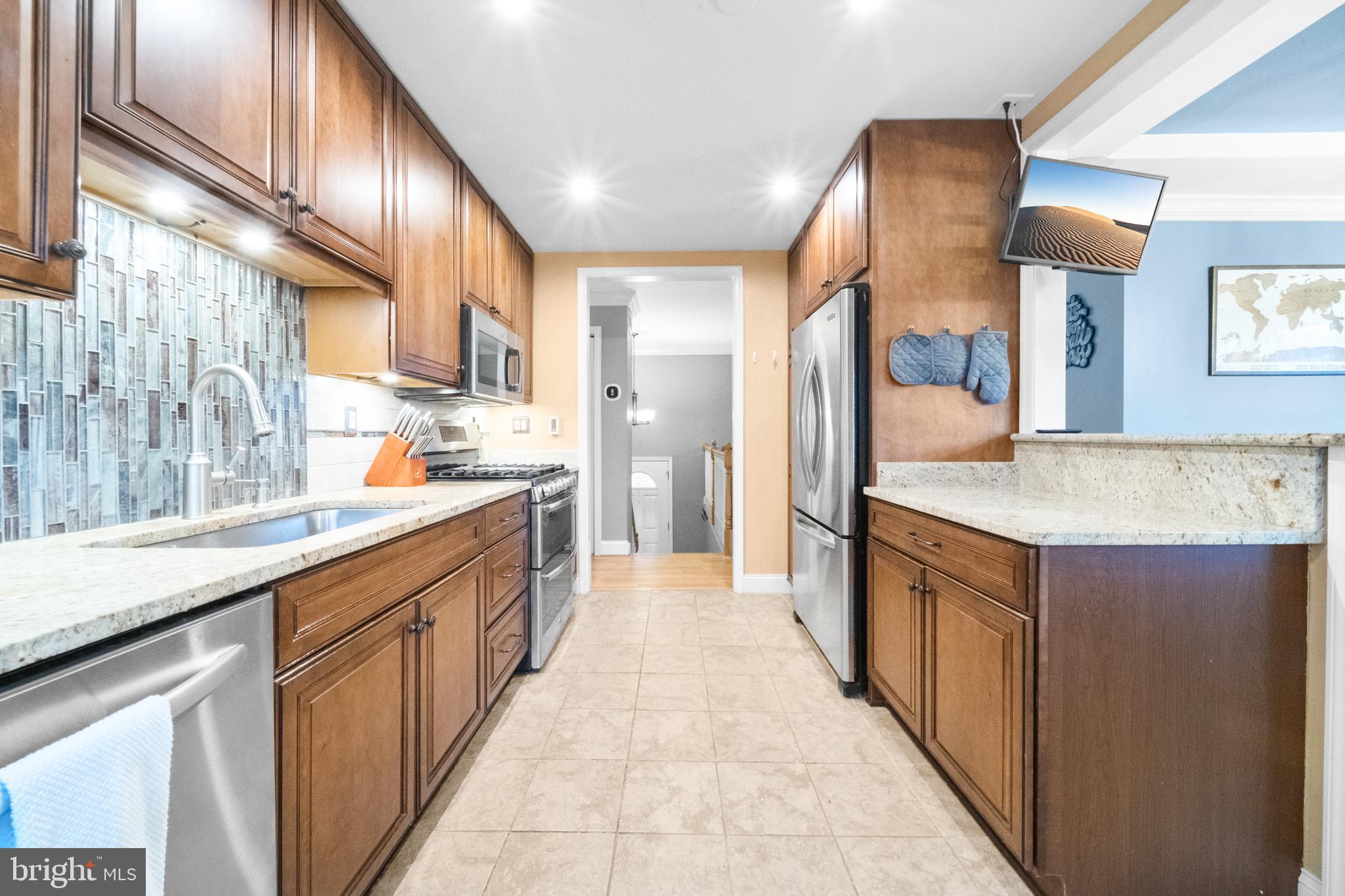 10600 Springmann Drive Fairfax, VA 22030 - Photo 12 of 78 a large kitchen with stainless steel appliances a sink and cabinets