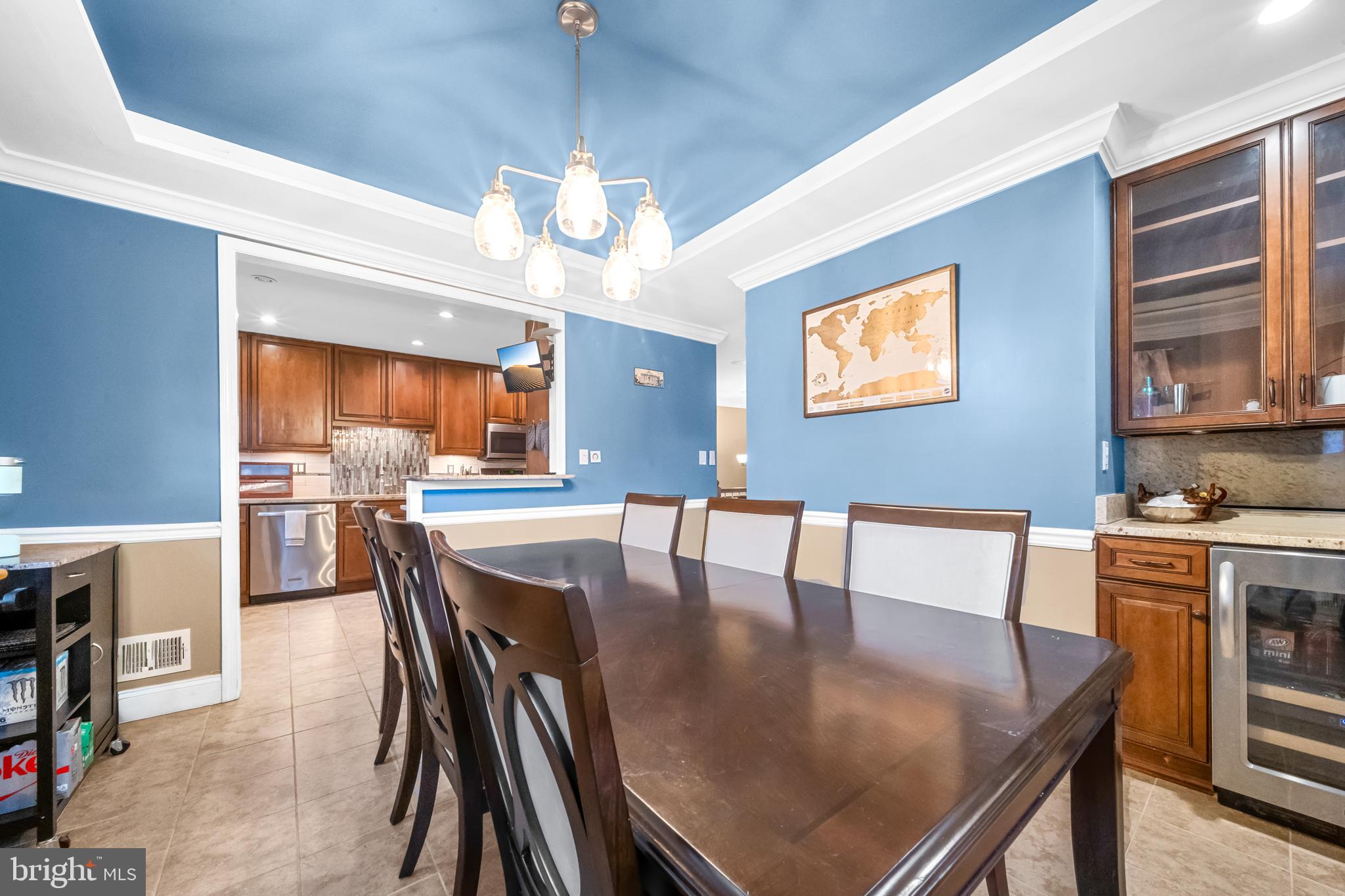 10600 Springmann Drive Fairfax, VA 22030 - Photo 13 of 78 a dining room with wooden floor a chandelier a wooden table and chairs