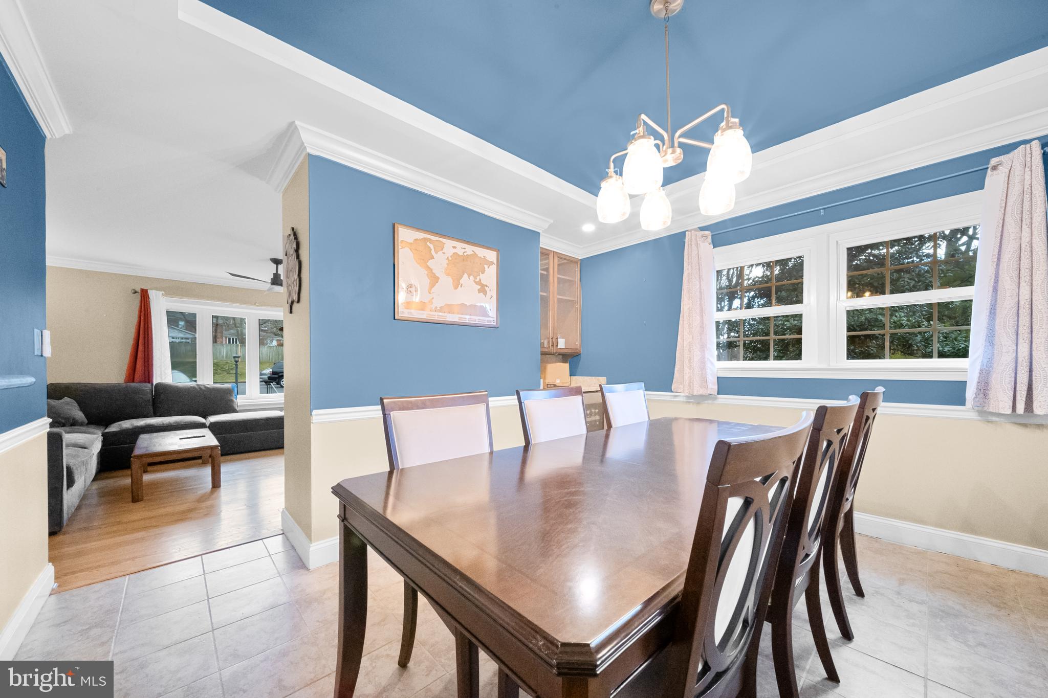 10600 Springmann Drive Fairfax, VA 22030 - Photo 17 of 78 a dining room with wooden floor a chandelier fan a wooden table and chairs