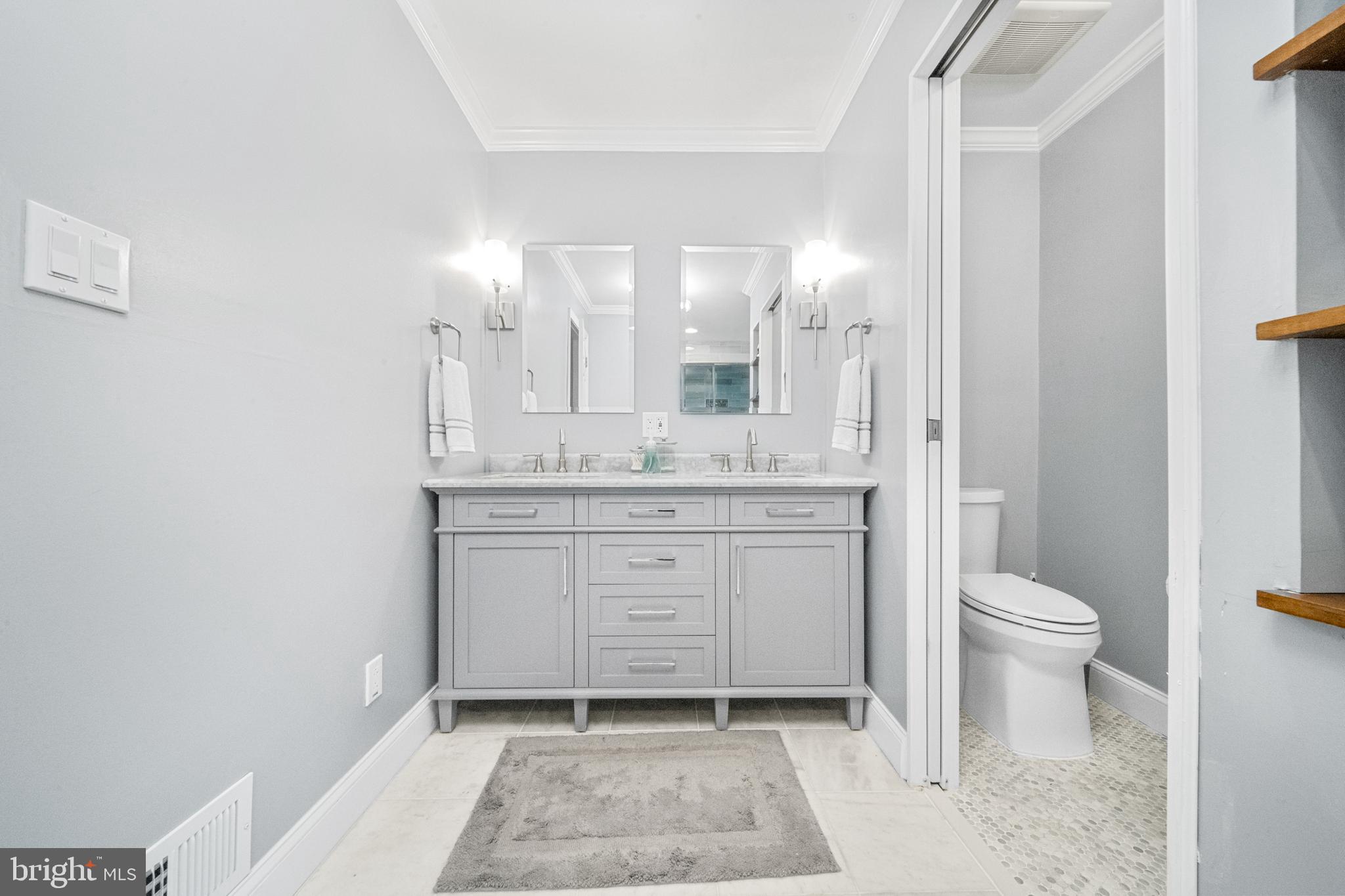 10600 Springmann Drive Fairfax, VA 22030 - Photo 31 of 78 a bathroom with a granite countertop sink toilet and shower
