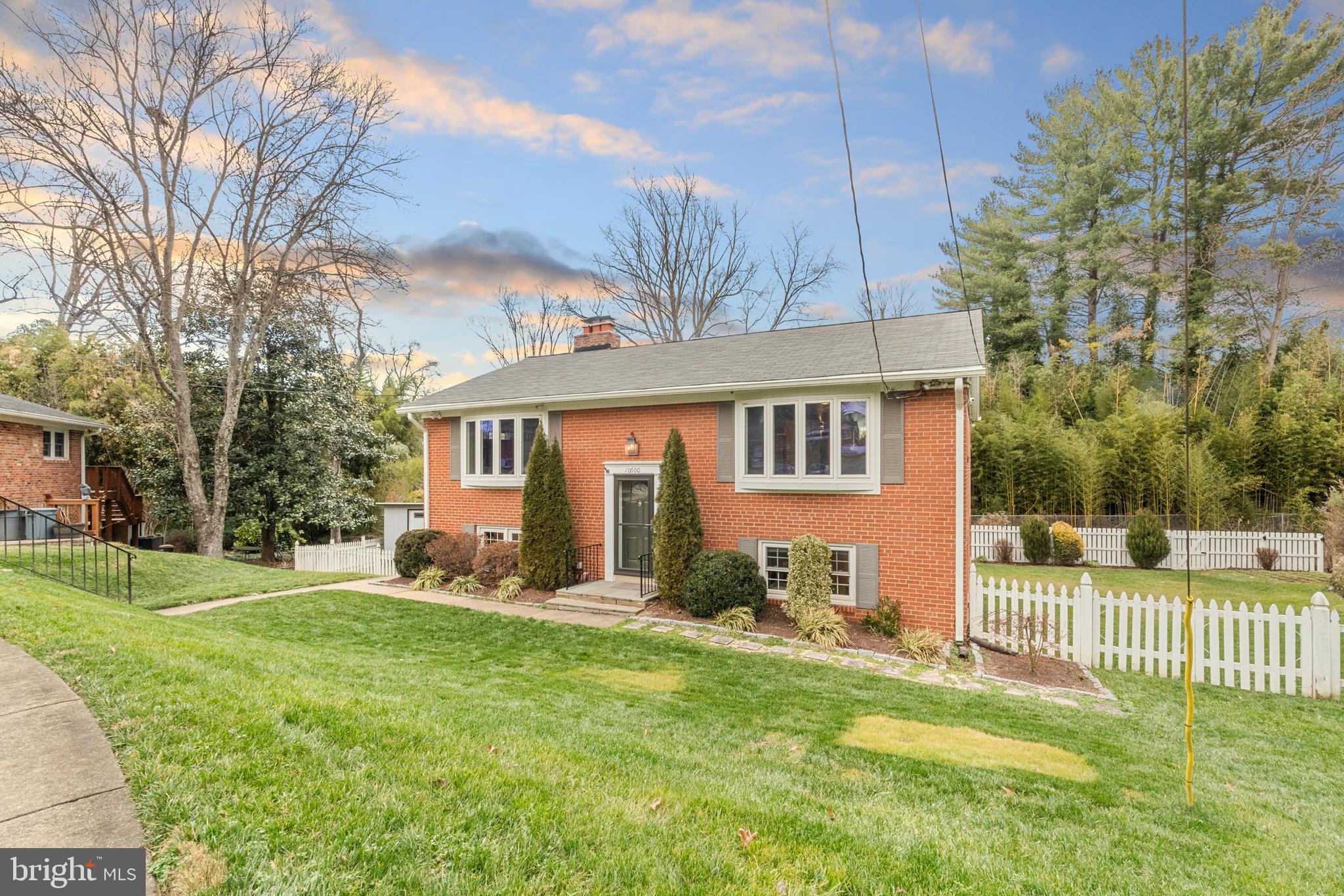 10600 Springmann Drive Fairfax, VA 22030 - Photo 4 of 78 a front view of a house with a yard and trees