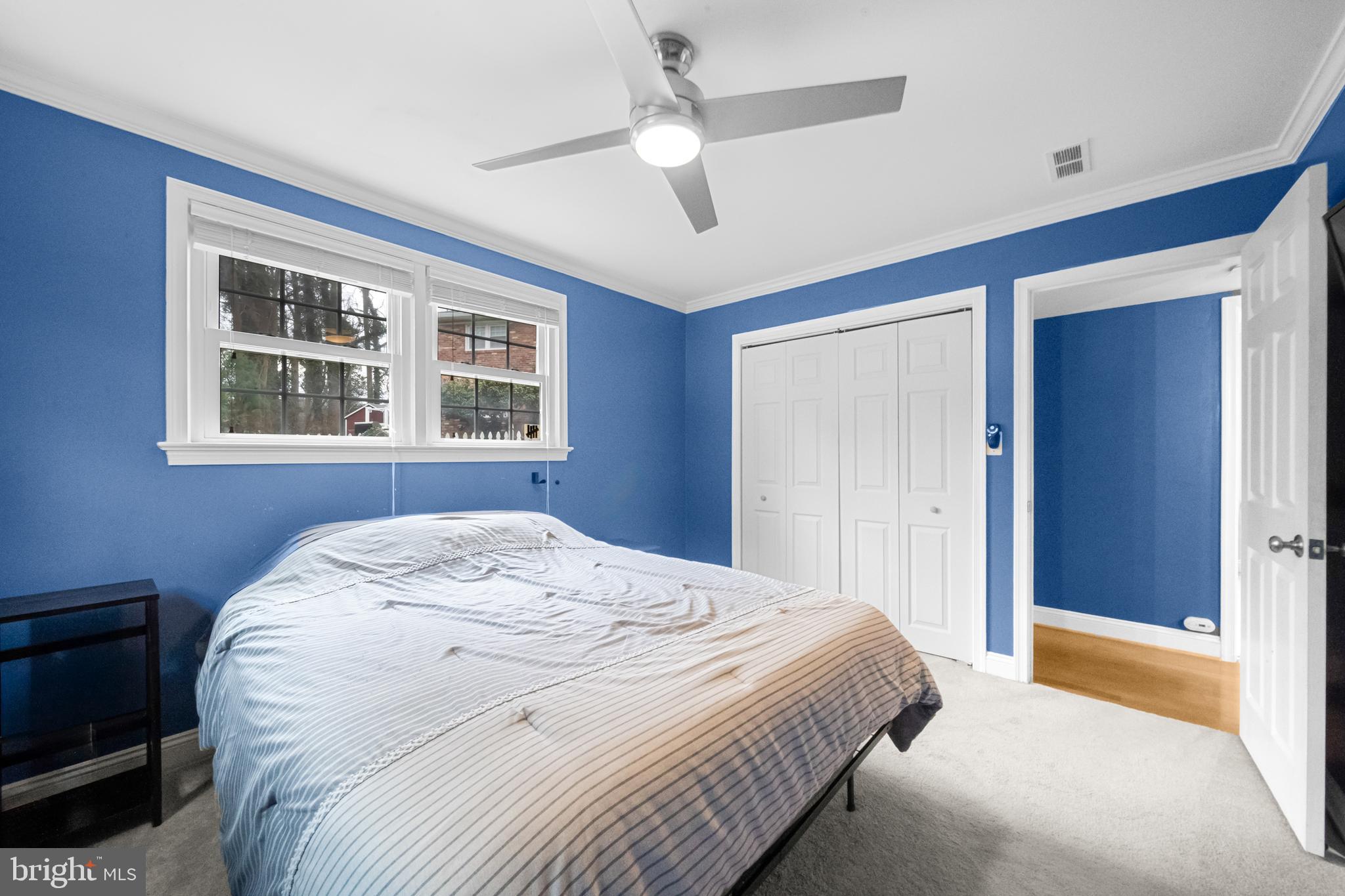 10600 Springmann Drive Fairfax, VA 22030 - Photo 50 of 78 a bedroom with a large bed and a chandelier