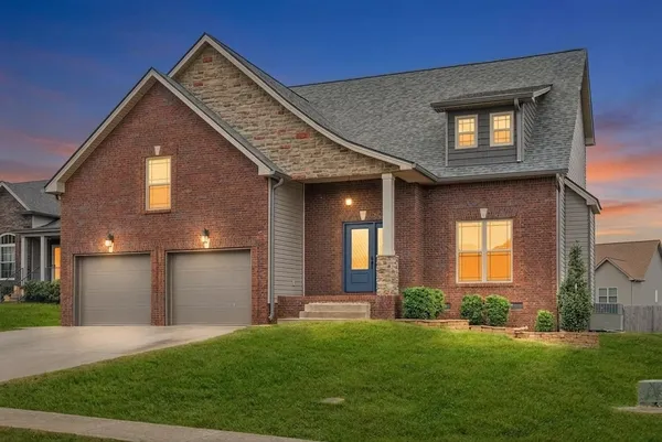 a front view of a house with a yard and garage