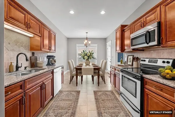 a kitchen with stainless steel appliances granite countertop a stove sink and microwave