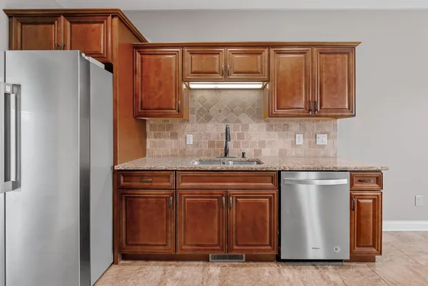 an empty room with windows and chandelier fan