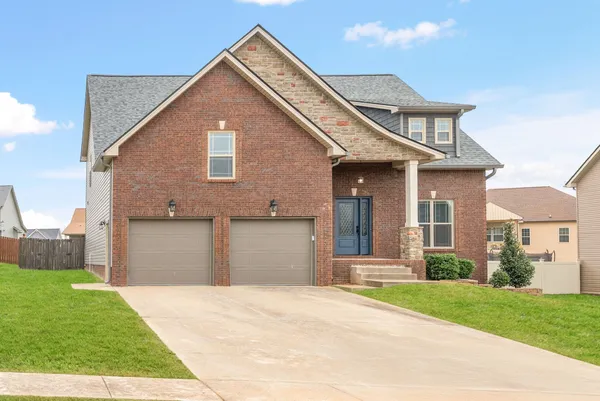 a front view of a house with a yard and garage
