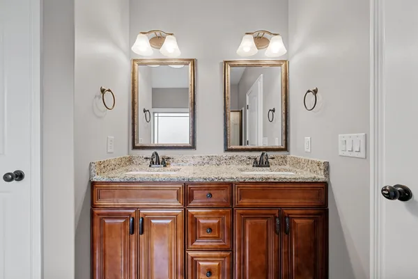 a bathroom with a double vanity sink and mirror