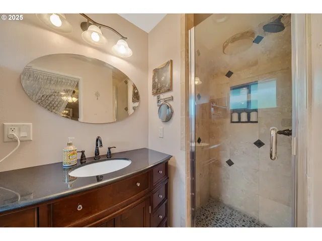 a bedroom with a bed and a ceiling fan