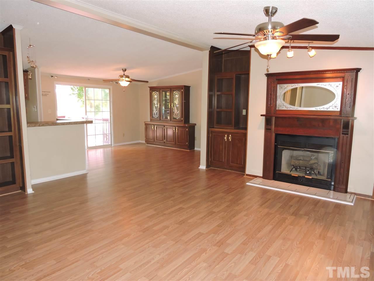 225 Bowling Road Roxboro, NC 27574 - Photo 2 of 19 a view of an empty room with a fireplace and a window