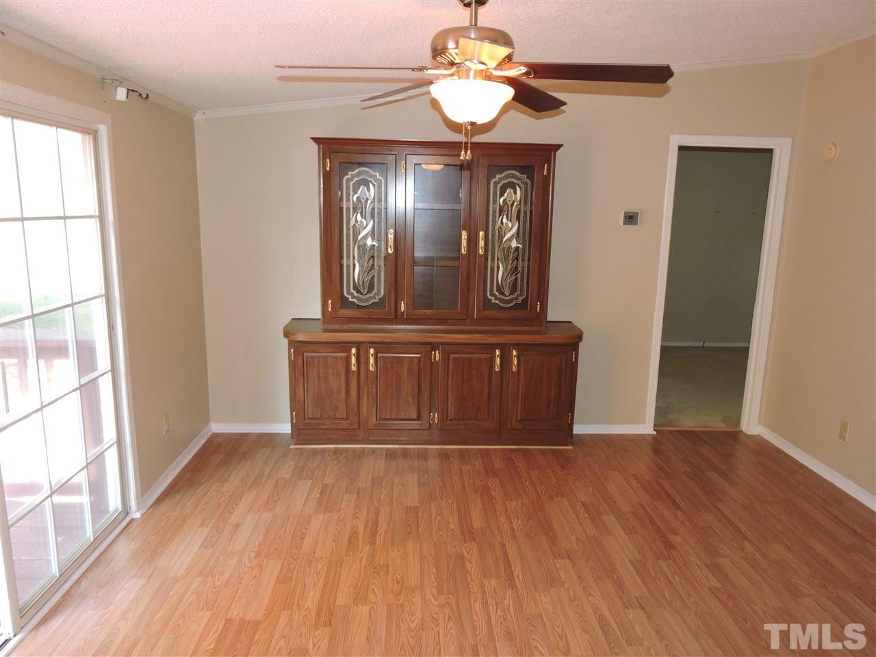 225 Bowling Road Roxboro, NC 27574 - Photo 11 of 19 a view of a hallway with wooden floor and a chandelier