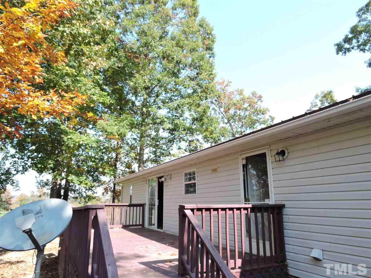 225 Bowling Road Roxboro, NC 27574 - Photo 15 of 19 a view of backyard with deck and outdoor seating