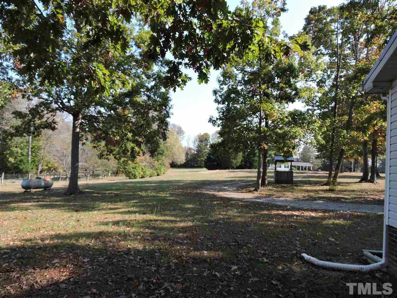 225 Bowling Road Roxboro, NC 27574 - Photo 17 of 19 a backyard of a house with trees