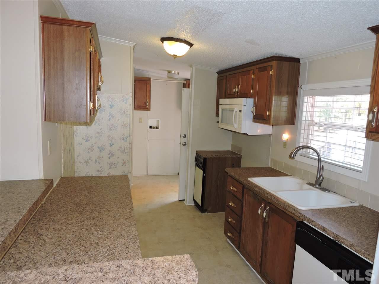 225 Bowling Road Roxboro, NC 27574 - Photo 3 of 19 a spacious bathroom with a sink double vanity granite and a mirror