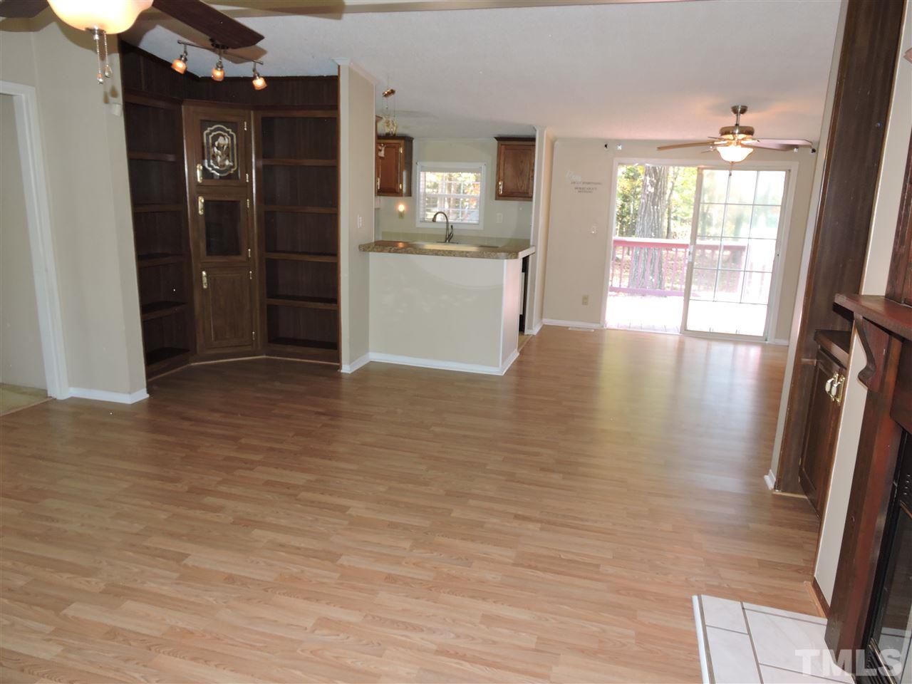 225 Bowling Road Roxboro, NC 27574 - Photo 4 of 19 wooden floor in an empty room with a window